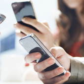 hands texting with mobile phones in cafe